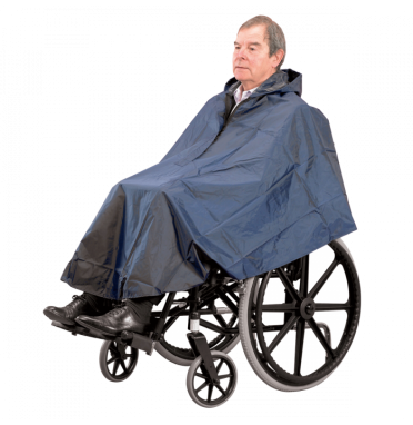 A man wearing a weatherproof wheelchair poncho cape in blue